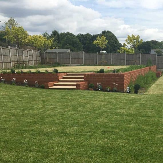 lawn on two levels with retaining wall and steps to upper terrace