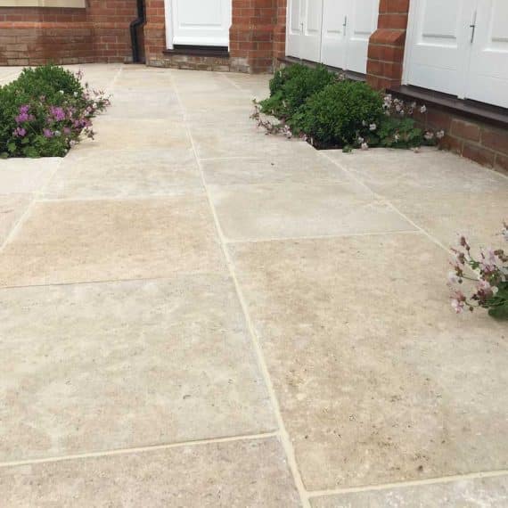 limestone patio with planting pockets between slabs