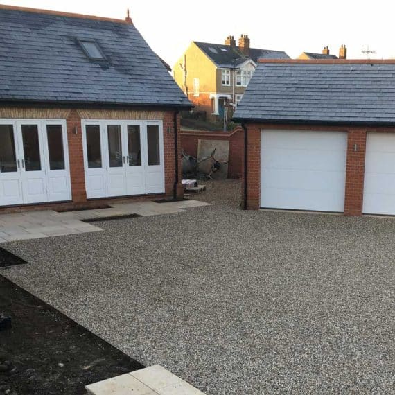 gravel driveway in courtyard with garages