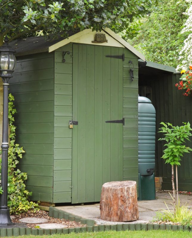 timber garden shed painted green and cream