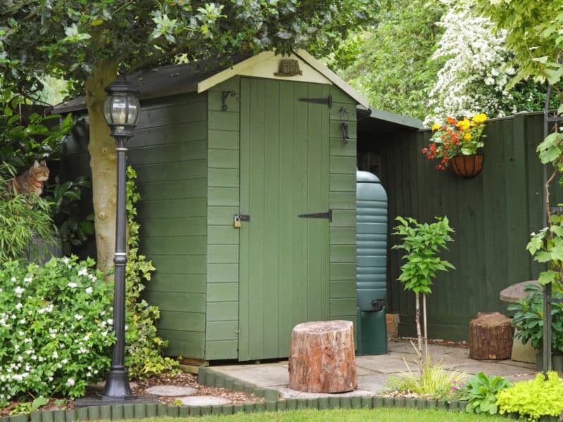 timber garden shed painted green and cream