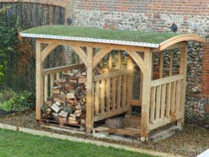 rustic style garden storage for logs has a living green roof