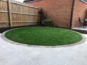 circular artificial grass lawn in modern back garden