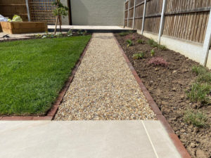 gravel path edged with brick pavers