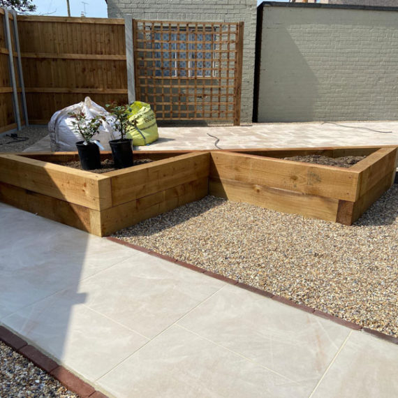 porcelain paver path with triangular shaped raised beds