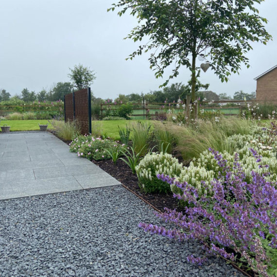 landscaping surfaces in neutral colour with purple and white planting