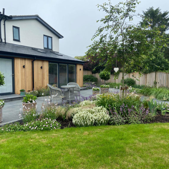 modern house with lawns and beautiful planting scheme