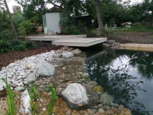 floating deck between summerhouse and pond