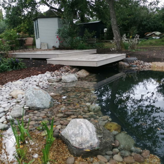 floating deck between summerhouse and pond