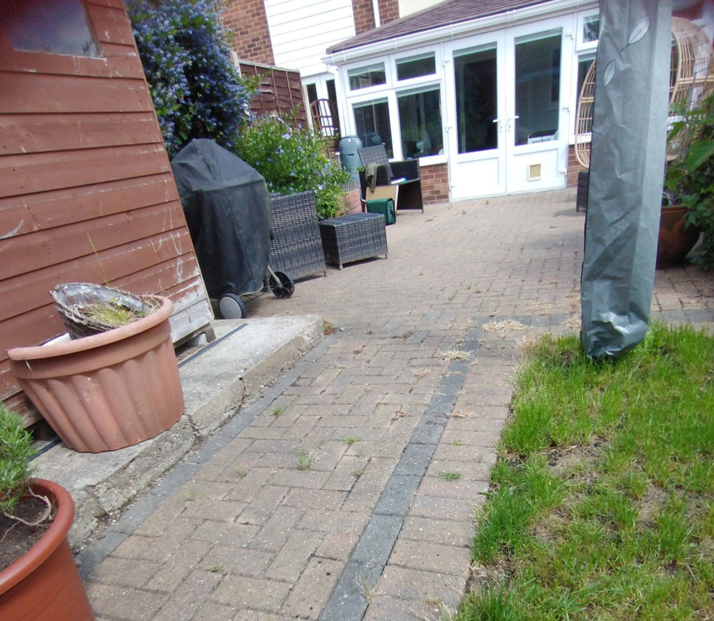 medium sized back garden with brick pavers