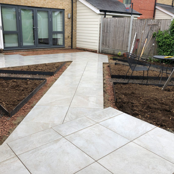 porcelain pavers forming a path with steel edged planting beds either side