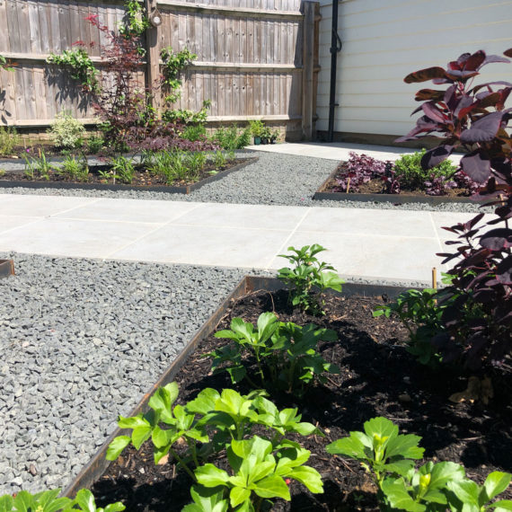 grey aggregate path directed by cream porcelain paving path