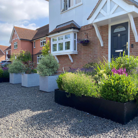 front garden of newbuild property with gravel garden and large square planters