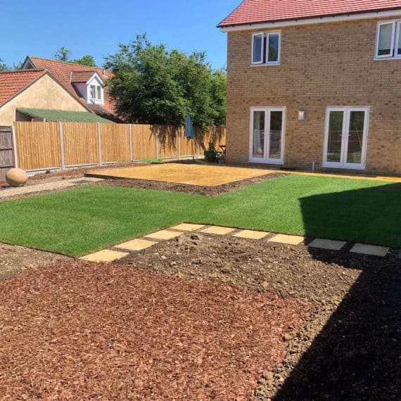newly turfed lawn with stepping stones and surrounding area for planting