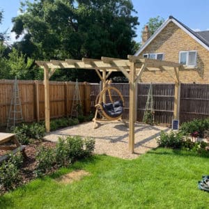 pretty timber pergola in a sunny corner of a family garden