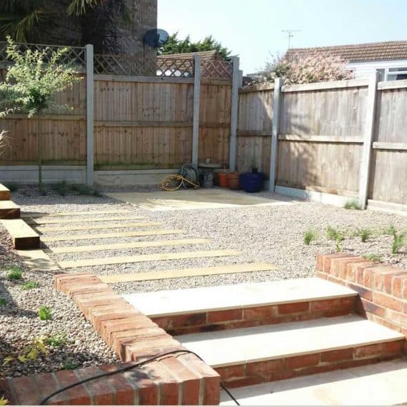 sturdy garden steps leading from patio to raised gravel garden