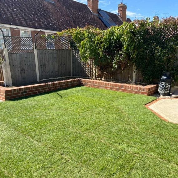 lawned terrace at the top of a sloping garden