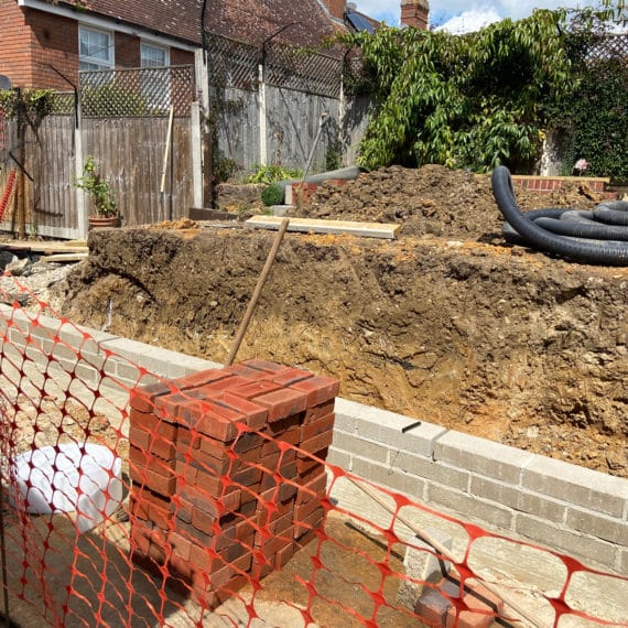 landscaping work in progress to build a high retaining wall