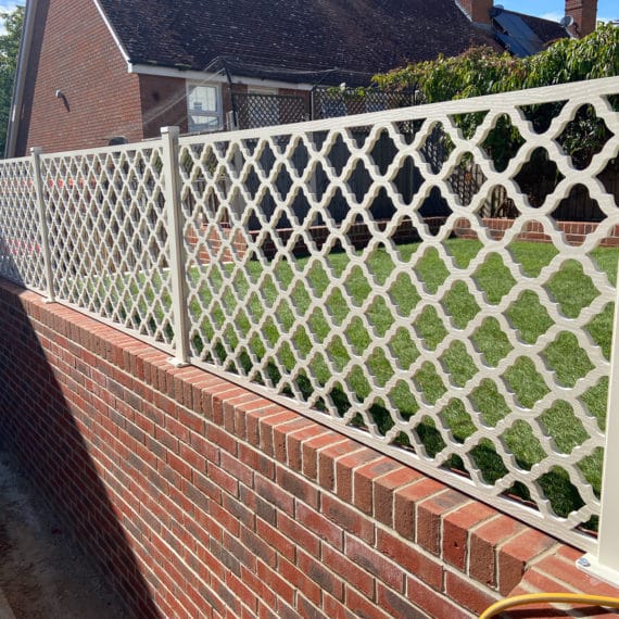 brick retaining wall with attractive garden screen fixed to the top for a safe balustrade