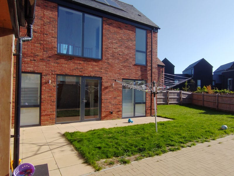 newbuild garden with l-shaped patio and washing line