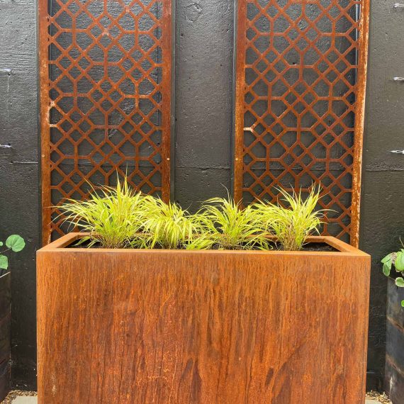 corten steel planter with two decorative corten steel screens behind