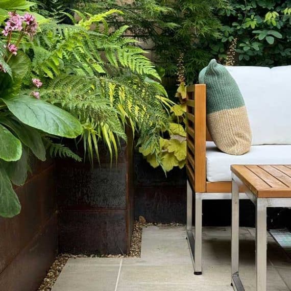 comfortable outdoor sofa immersed in natural jungle style planting