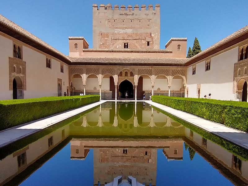 Alhambra palace in spain reflected in a formal pool