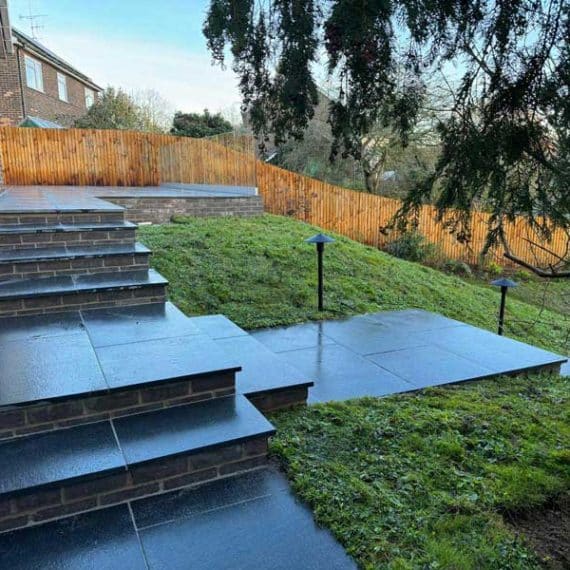 black granite landscaped steps leading to a large patio