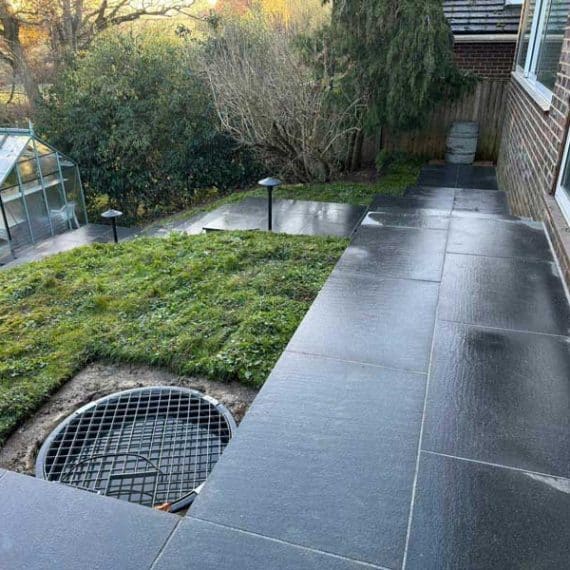 Juxtaposition between patio and path with water feature sump installed