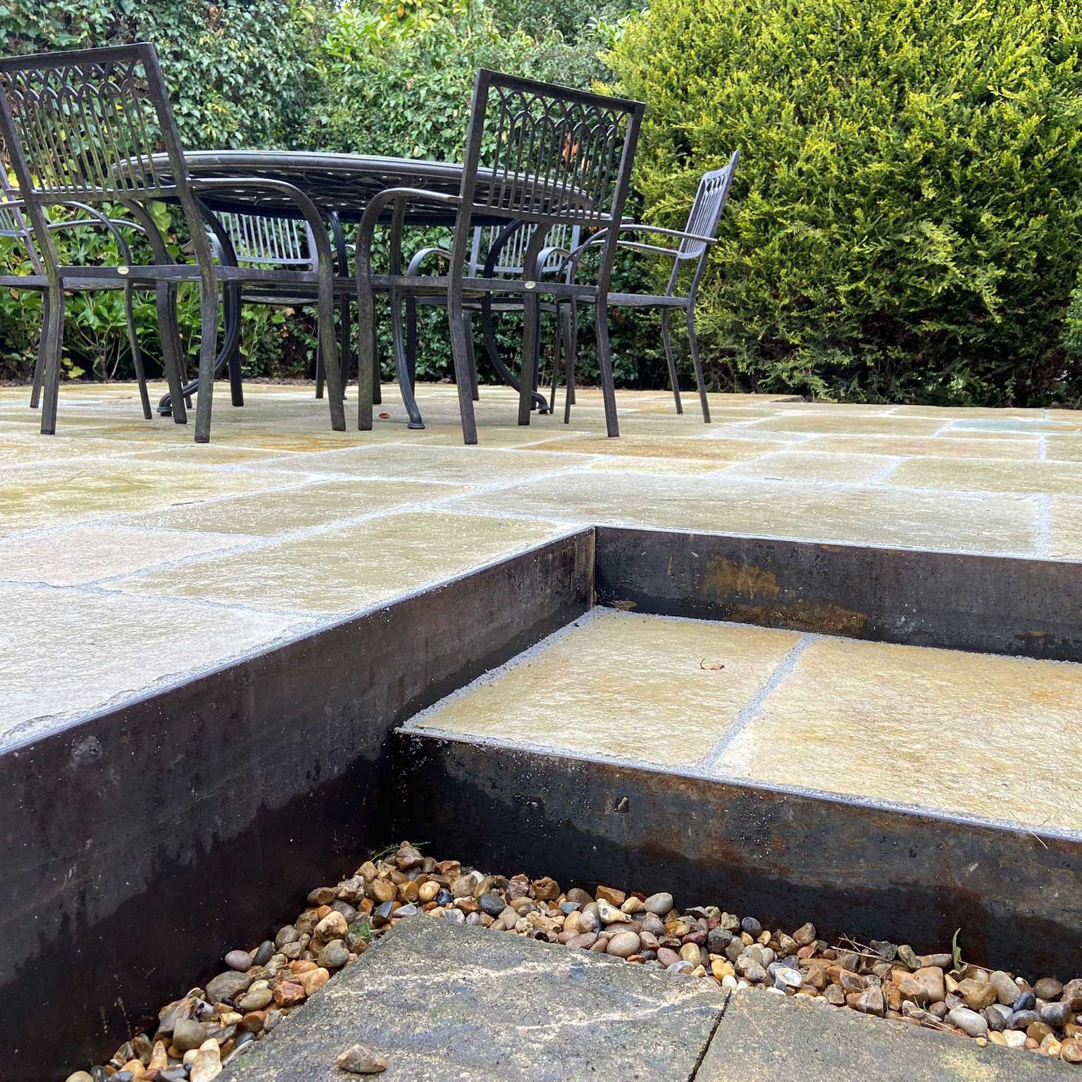 natural stone patio with wrought iron garden furniture