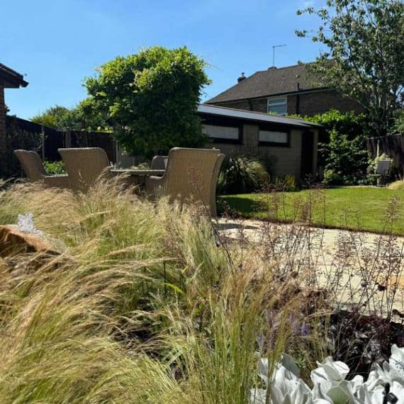 well appointed patio with lawns and planting all around