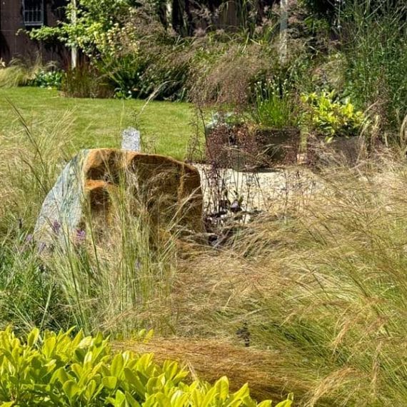 bubbling water feature amidst attractive foliage plants